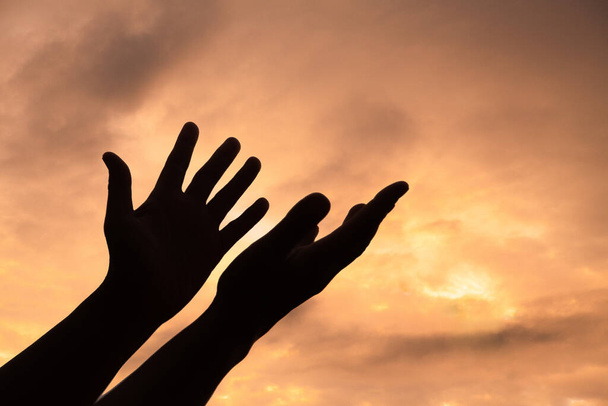 Person human hands open palm up worship or pray for god. background is sunrise. Concept for Christian, Christianity, Catholic religion, divine, heavenly, celestial or god. - Foto, Imagen
