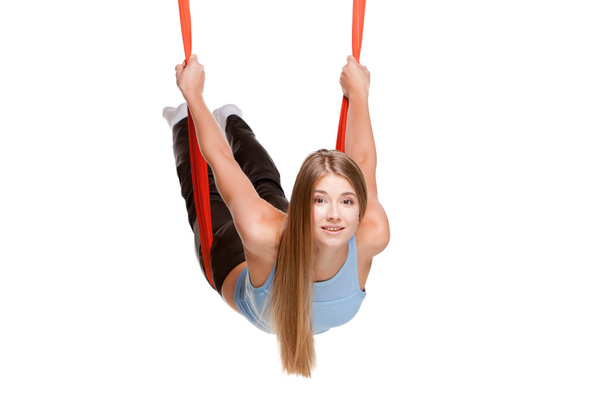 Young woman doing anti-gravity aerial yoga - Фото, зображення