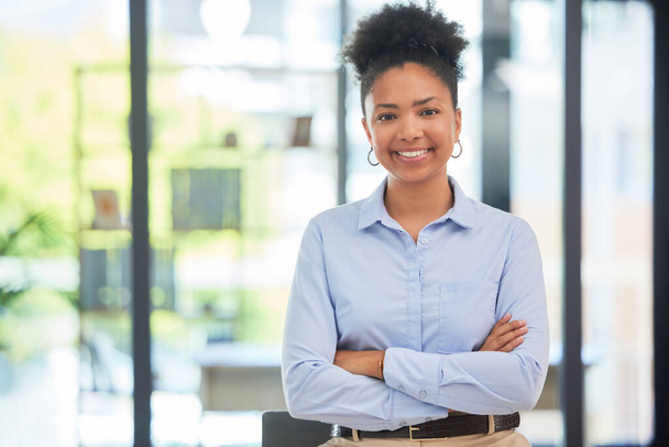 Success, leadership and professional businesswoman smiling while in a modern corporate office. Portrait of a confident worker, manager and young female leader standing with crossed arms at a company - Photo, image