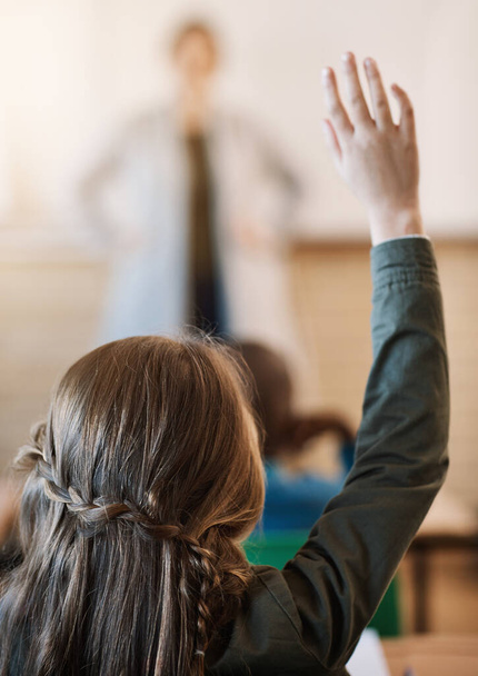 Taking part in class activities. an unrecognizable elementary school girl hand raised in the classroom - 写真・画像