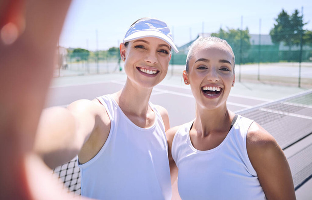 Selfie taking team of female tennis players on the court after a game, match or tournament portrait. Fit sporty teammates, athletes or professionals relax after being active, exercise and training. - Valokuva, kuva