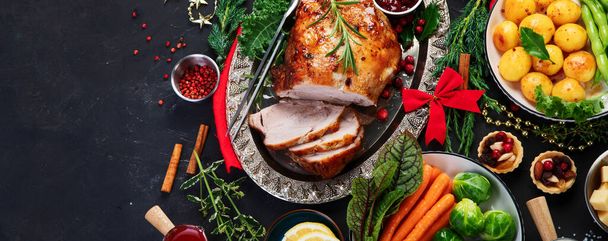 Traditional Christmas dinner on dark background. Holiday food. Top view, panorama, copy space - Foto, immagini