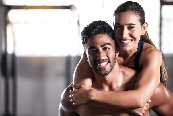 Fitness couple, gym friends and team hugging, holding and celebrating successful workout, training and exercise together. Portrait of smiling, happy and healthy man and woman after wellness teamwork. - Foto, Bild