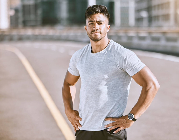 Fitness, sports and runner with motivation, wellness goals and vision in city, town or dowtown. Portrait of active, athletic or healthy man on street for routine running workout, exercise or training. - Photo, image