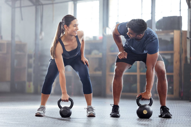 Strong, wellness couple doing kettlebell weight exercise, workout or training inside a gym. Happy sports people or trainer motivation, exercising with fitness equipment for muscle, strength or health. - Valokuva, kuva