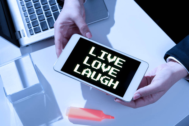 Conceptual caption Live Love Laugh, Concept meaning Be inspired positive enjoy your days laughing good humor Businesswoman Presenting Important Message On Mobile Phone Screen On Desk. - Foto, immagini