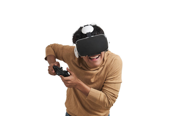 Young peruvian man playing video games with a joystick and vr headset. Isolated over white background. - Zdjęcie, obraz
