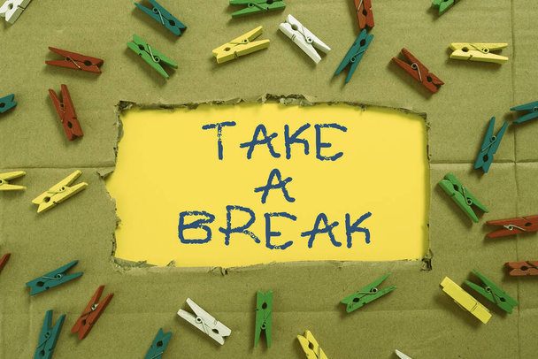 Text sign showing Take A Break, Conceptual photo Resting Stop doing something recreation time get out of work Important Ideas Written Under Ripped Cardboard With Colored Pegs Around. - Fotó, kép