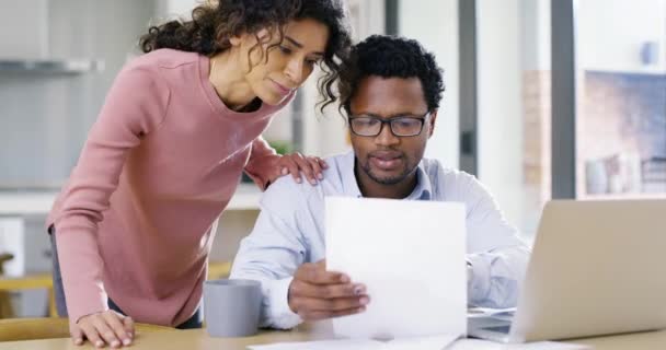 Home finance, budget planning and money management with a young couple reading paper work, talking and discussing their savings and investment for the future. Man and woman doing finances on a laptop. - Séquence, vidéo