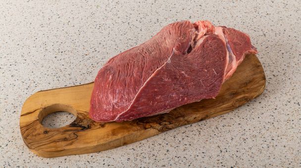 Fresh piece of veal meat on a cutting board - Foto, Imagen