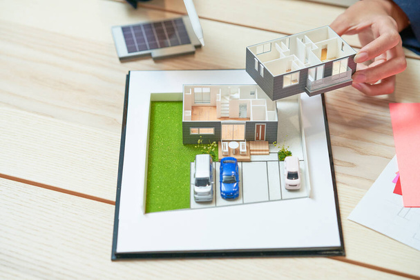 A detailed model of a house on a table in the room - Photo, image