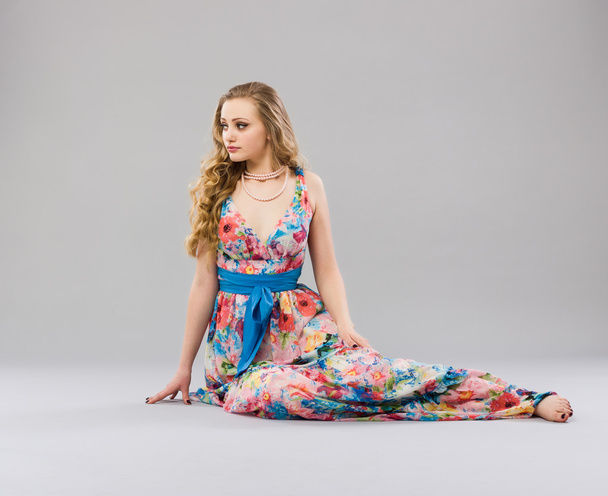 Woman sitting in  trendy long dress - Photo, Image