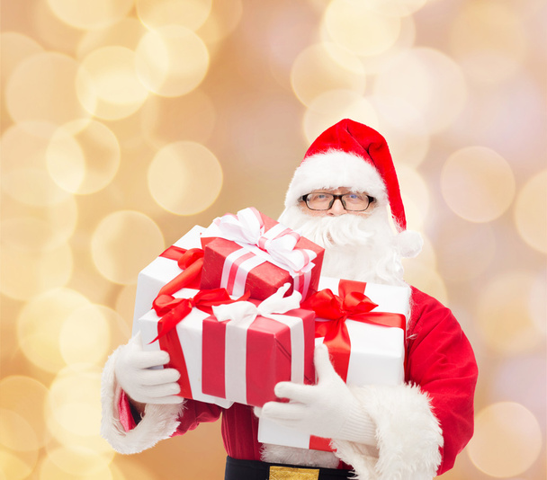 man in costume of santa claus with gift boxes - Foto, Imagem