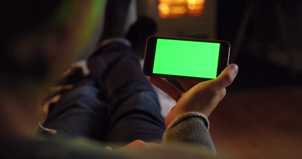 Green screen, copyspace and chromakey on phone, person watching a movie online and streaming videos while relaxing at home. Relaxed, carefree and casual man looking at an app and sitting on couch. - Imágenes, Vídeo