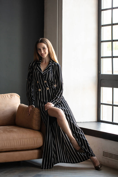 beautiful woman posing in studio wearing striped dress  - Foto, immagini