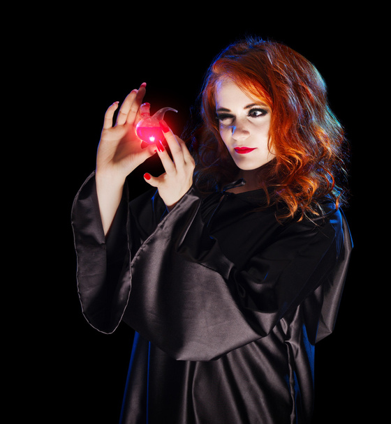 Young witch with potion - Foto, afbeelding