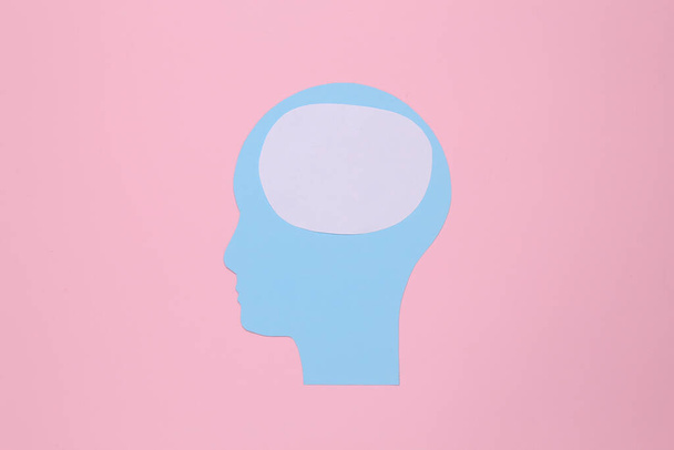 Paper cut human head with blank space for brain on pink background - Fotó, kép