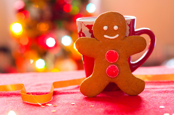 The gingerbread man on the background of the Christmas tree - Photo, Image
