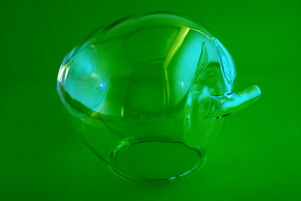 Glass apple on a green background - Φωτογραφία, εικόνα