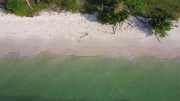 Beautiful sea waves and white sand beach in the tropical island. Soft waves of blue ocean on sandy beach background from top view from drones. Concept of relaxation and travel on vacation. - Footage, Video