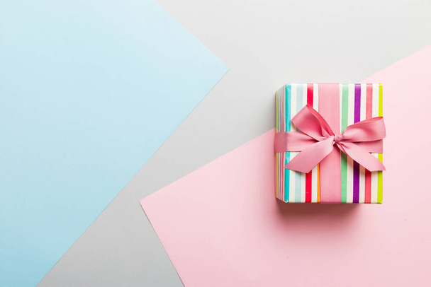 holiday paper present tied pink ribbon bow top view with copy space. Flat lay holiday background. Birthday or christmas present. Christmas gift box concept with copy space. - Foto, Imagem