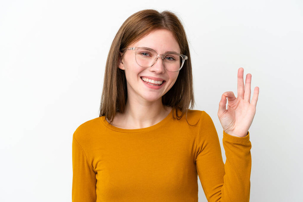 Young English woman isolated on white background With glasses and doing OK sign - Photo, Image