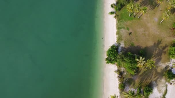Beautiful sea waves and white sand beach in the tropical island. Soft waves of blue ocean on sandy beach background from top view from drones. Concept of relaxation and travel on vacation. - Footage, Video