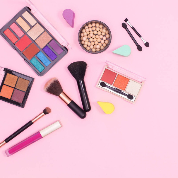 Colorful make up products layout on pastel pink background. Flat lay - Zdjęcie, obraz