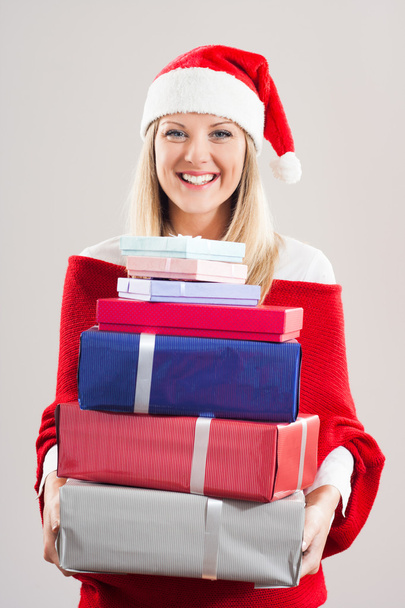 Girl in Santa's hat with Christmas gifts - Fotó, kép