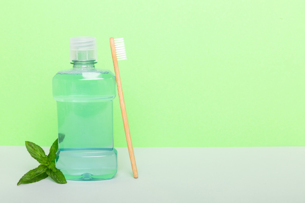 Mouthwash and fresh mint on colored background, top view with copy space for text. - Photo, Image