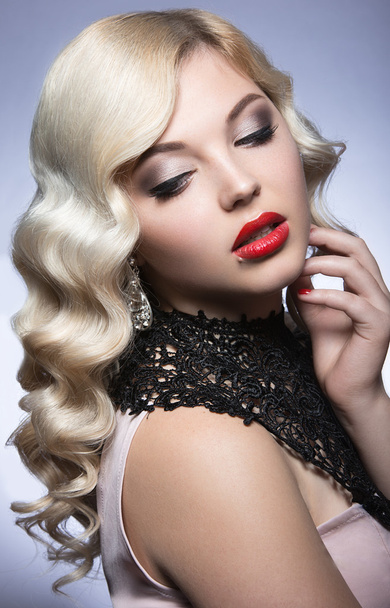 Beautiful blonde in a Hollywood manner with curls, red lips and lace dress. Beauty face. - 写真・画像