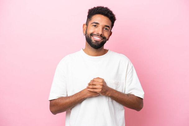 Young Brazilian man isolated on pink background laughing - Photo, image