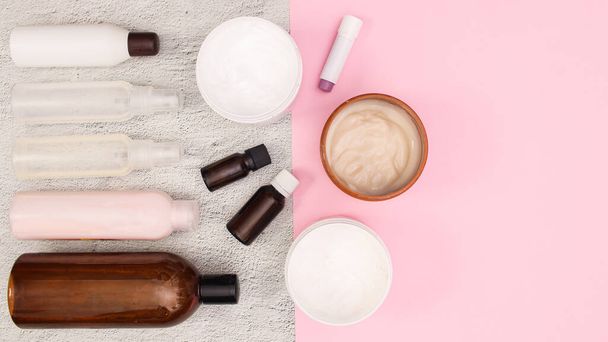 Bottles of Beauty and cosmetics products layout on white and pink background with copy space. Flat lay - Foto, imagen