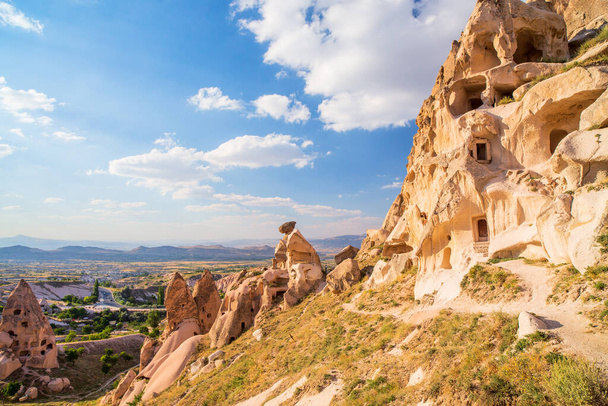 View of rock formations and fairy chimneys near Uchisar castle in Cappadocia Turkey - Foto, afbeelding
