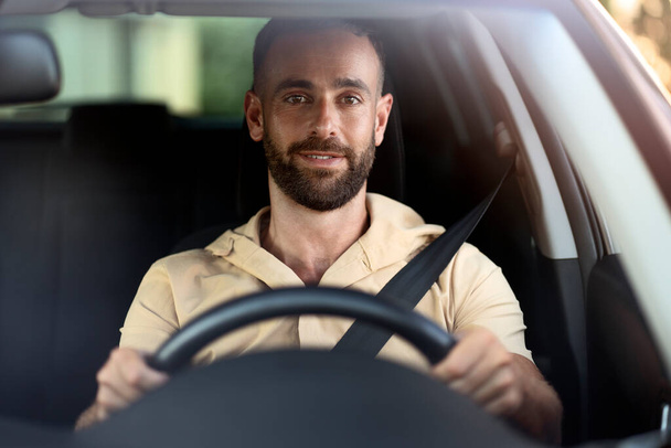 Smiling handsome man driving a car, road trip. Seat belt, safety driving concept - Photo, Image