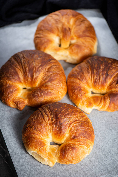 Detailed close-up of delicious buttery traditional croissants with a crescent moon shape. - Foto, Imagen