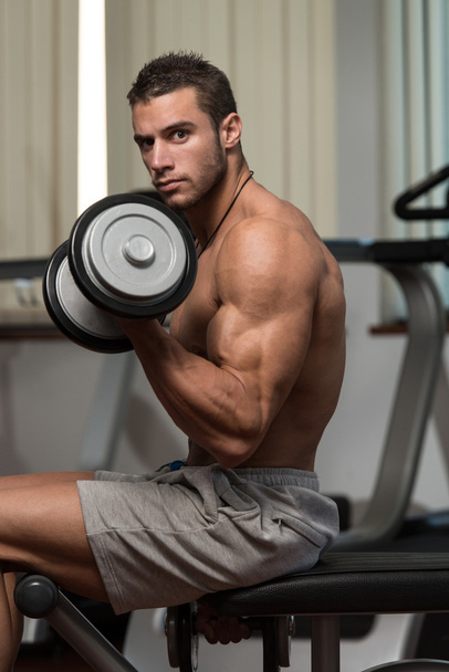 Healthy Young Man Doing Exercise For Biceps - Foto, Imagem