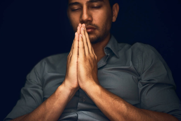 Give us this day our daily bread. Closeup shot of a young man praying with his eyes closed - Fotoğraf, Görsel