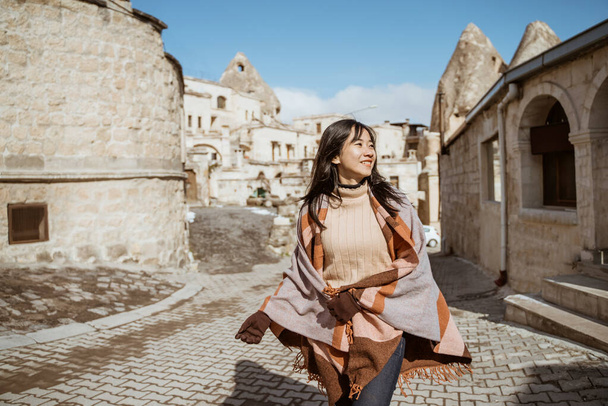 happy attractive woman walking around the town of goreme in cappadocia - Photo, Image