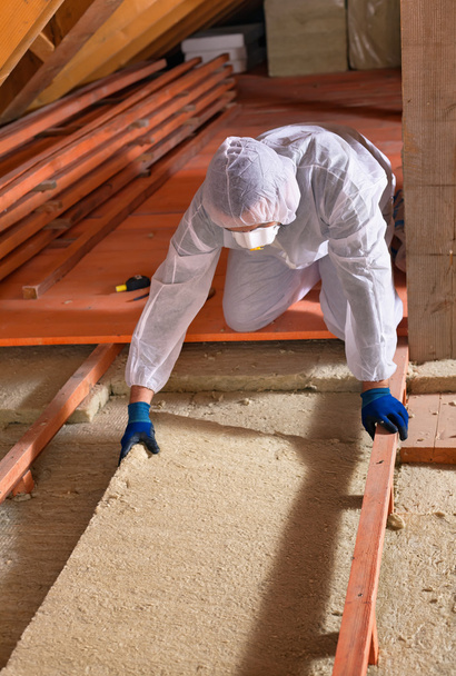 Man laying thermal insulation layer - wearing protective clothin - Photo, Image