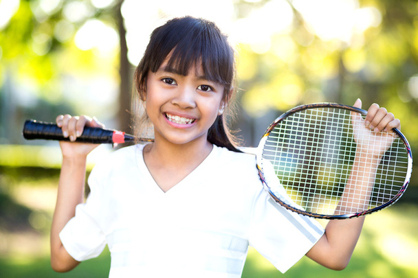 Little asian girl holding a badminton racket - Фото, зображення