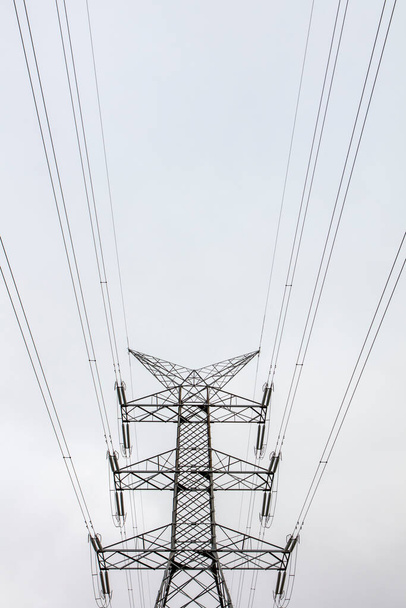 Photograph of a large steel transmission tower and associated cables running through a valley in regional New South Wales in Australia - Fotó, kép