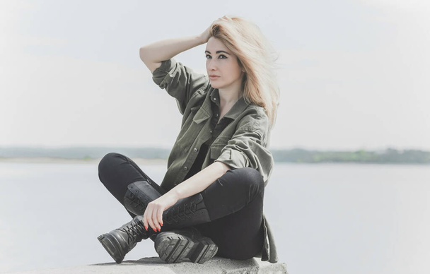 Modern blonde woman mix race in jeans jacket, fashionable details on a model, concept of trend in wardrobe - Foto, Imagen