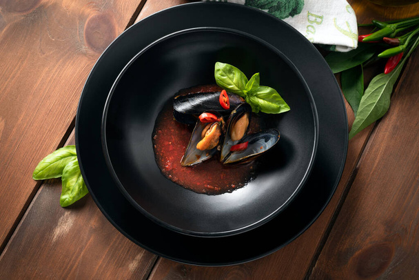 Delicious cozze alla sorrentina, a recipe of mussels with tomato sauce, italian food, top view  - Fotó, kép