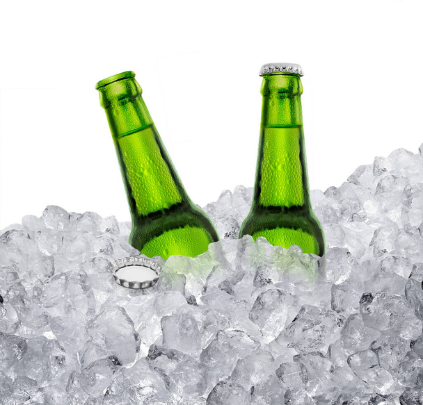 Beer bottle with water drops of cold beverage, ice cube a of juicy. Summer refreshing drink - Foto, imagen