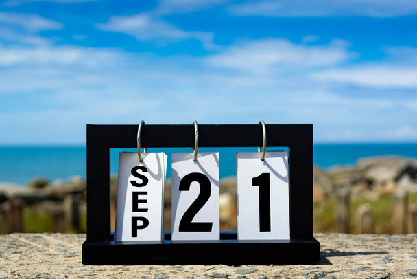 Sep 21 calendar date text on wooden frame with blurred background of ocean. Calendar date concept. - Photo, image