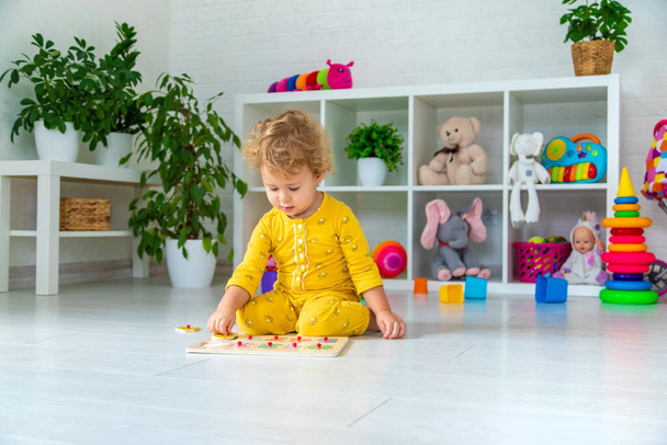 Children play with toys in the room. Selective focus. Kid. - Foto, Bild