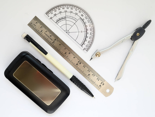 school supplies pencils ruler compasses protractor and phone on white background - Valokuva, kuva