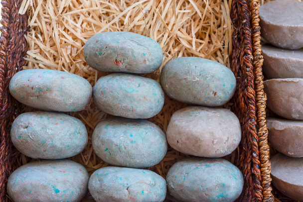 Stone soaps in the basket at craft street market stall. Selective focus. Natural light. - 写真・画像