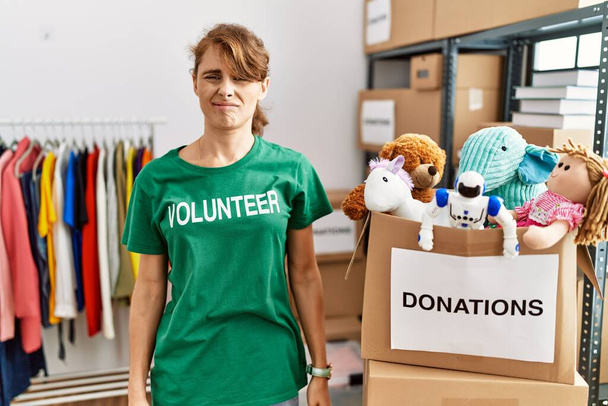 Beautiful caucasian woman wearing volunteer t shirt at donations stand depressed and worry for distress, crying angry and afraid. sad expression.  - Φωτογραφία, εικόνα